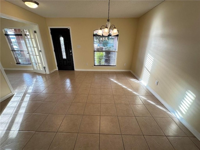 tiled entryway with an inviting chandelier