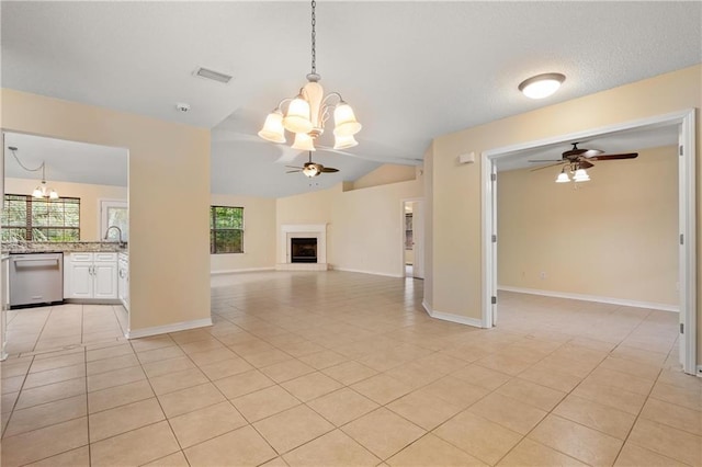 unfurnished living room featuring vaulted ceiling, ceiling fan with notable chandelier, and light tile patterned floors