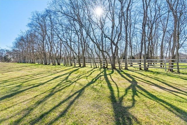 view of yard featuring fence and a rural view