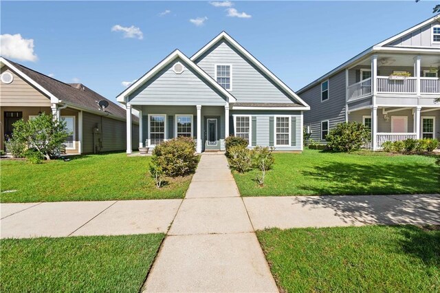 view of front of home with a balcony, a porch, and a front yard