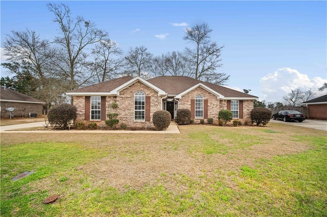 ranch-style home featuring a front yard