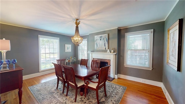 167 Glenwood St, Mobile, AL 36606 - dining room with a chandelier, plenty of natural light, ornamental molding, light wood finished floors, and baseboards