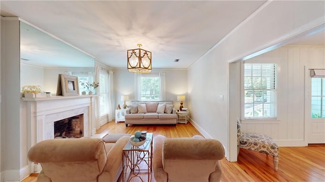 167 Glenwood St, Mobile, AL 36606 - living room with wood finished floors, a chandelier, ornamental molding, and a premium fireplace