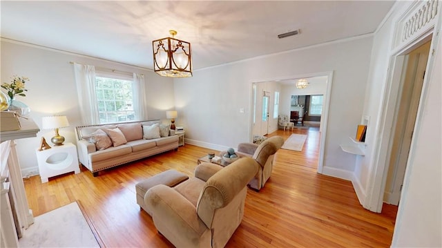 167 Glenwood St, Mobile, AL 36606 - living room with a chandelier, ornamental molding, light wood finished floors, and baseboards