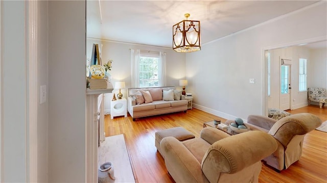 167 Glenwood St, Mobile, AL 36606 - living area featuring a chandelier, ornamental molding, light wood finished floors, and baseboards