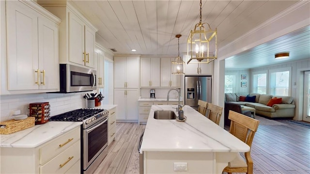 167 Glenwood St, Mobile, AL 36606 - kitchen with appliances with stainless steel finishes, a sink, light wood-style floors, wooden ceiling, and a center island with sink