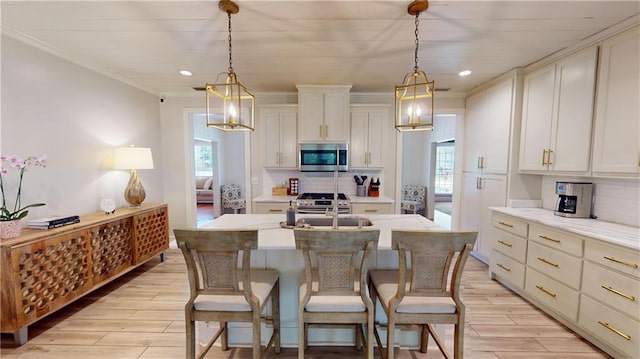 167 Glenwood St, Mobile, AL 36606 - kitchen featuring stainless steel appliances, backsplash, ornamental molding, light wood-type flooring, and light countertops