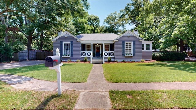 167 Glenwood St, Mobile, AL 36606 - view of front of house with covered porch and a chimney