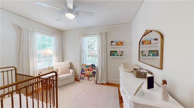 167 Glenwood St, Mobile, AL 36606 - bedroom featuring a crib, wood finished floors, a ceiling fan, and baseboards