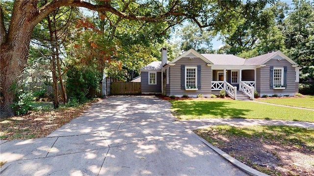 167 Glenwood St, Mobile, AL 36606 - ranch-style home featuring concrete driveway, covered porch, and a chimney