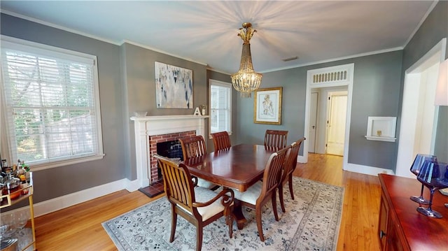 167 Glenwood St, Mobile, AL 36606 - dining space featuring a chandelier, plenty of natural light, light wood finished floors, and crown molding