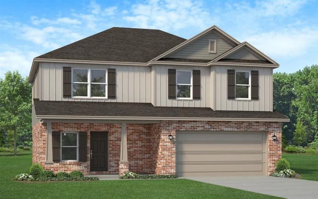 view of front facade with a front yard and a garage