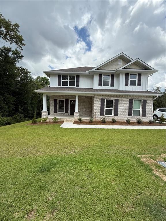 3557 Meadow Ln E, Mobile, AL 36618 - view of front of home with a porch, a front lawn, and brick siding