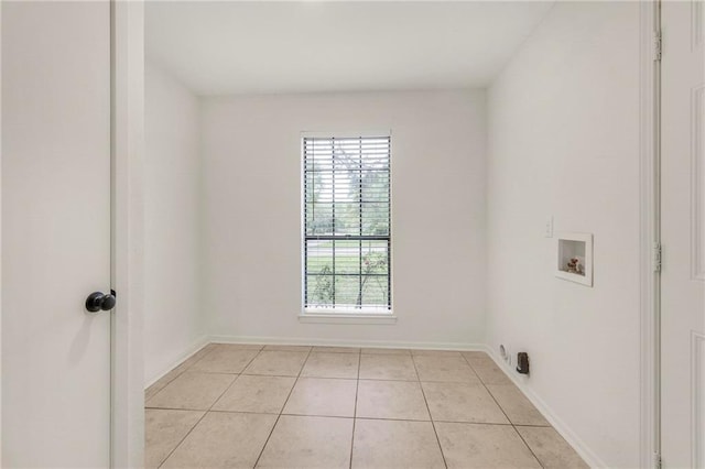 laundry room with light tile patterned floors, laundry area, baseboards, and hookup for a washing machine