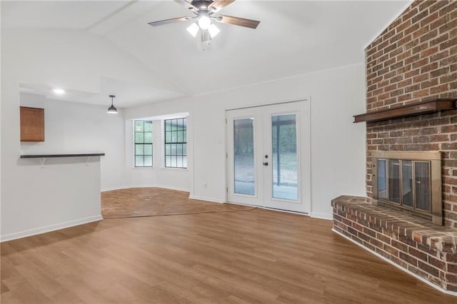unfurnished living room featuring ceiling fan, wood finished floors, lofted ceiling, french doors, and baseboards
