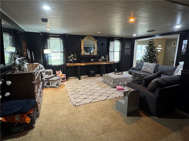 carpeted living room featuring plenty of natural light