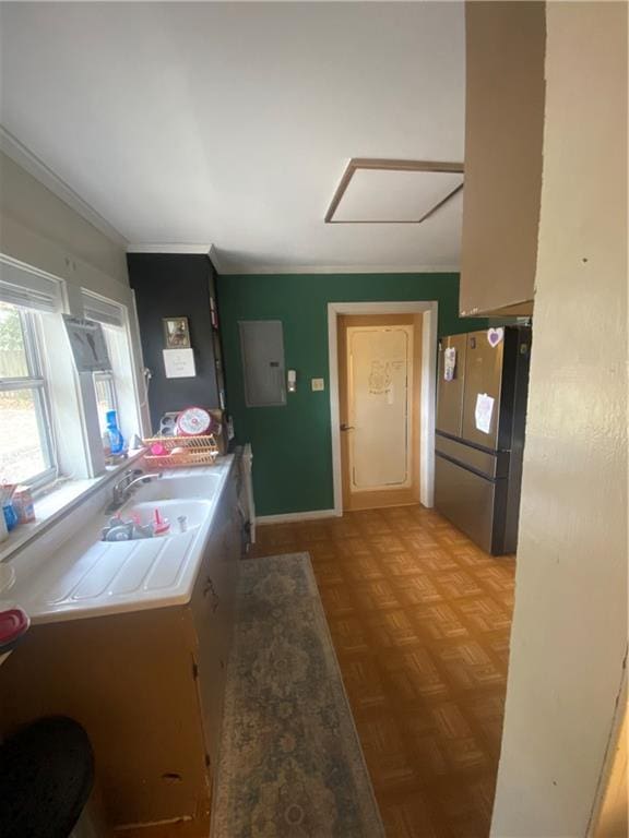 kitchen with stainless steel fridge, sink, electric panel, and light parquet floors