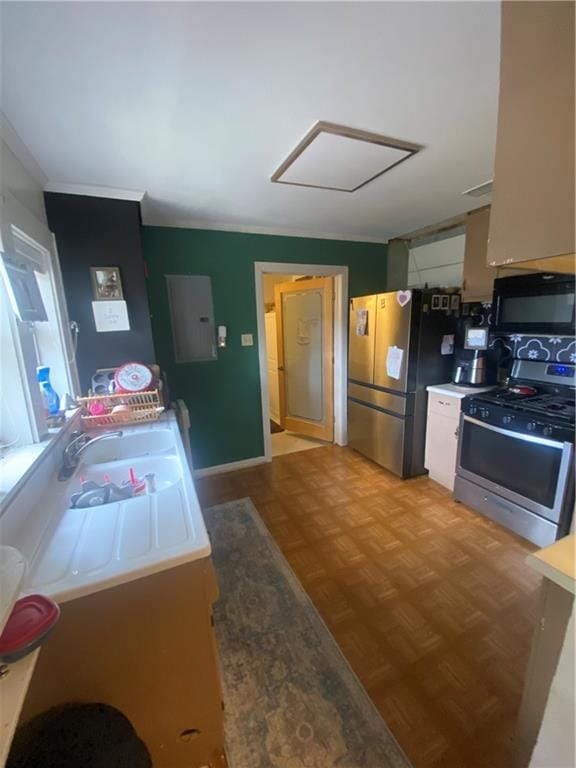 kitchen featuring electric panel, light parquet floors, and appliances with stainless steel finishes