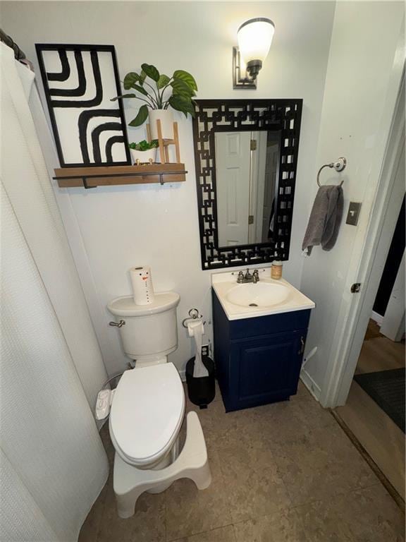 bathroom featuring vanity and toilet