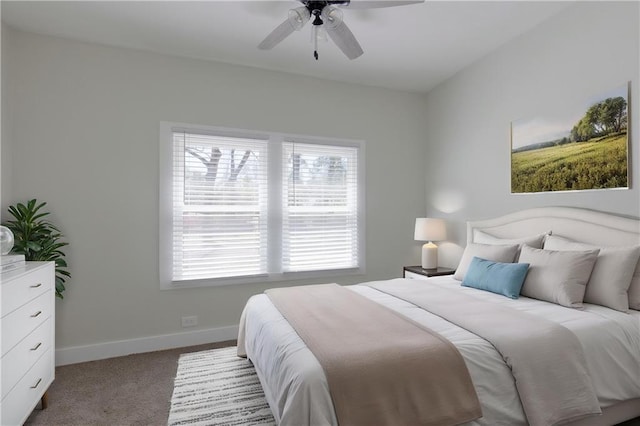 carpeted bedroom featuring baseboards and ceiling fan