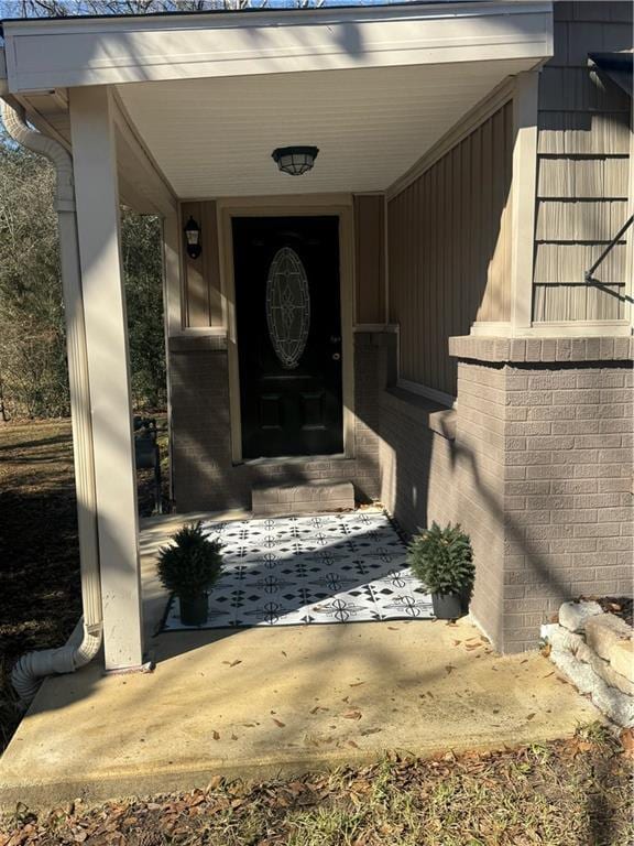 property entrance featuring brick siding