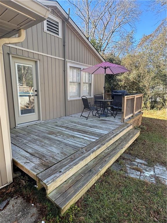 wooden deck featuring outdoor dining area