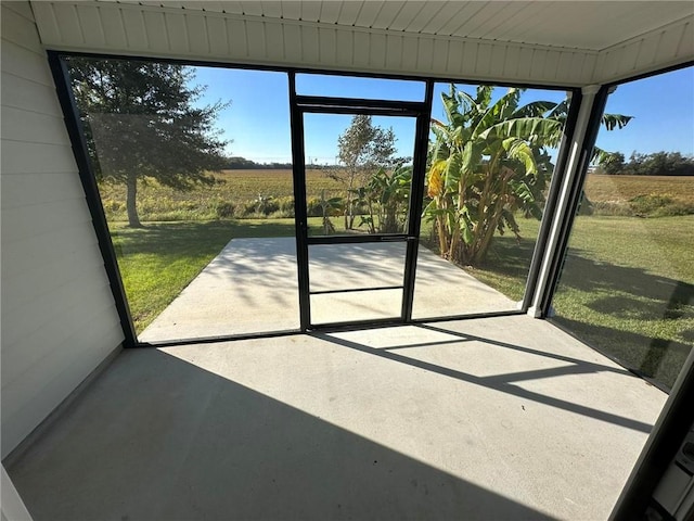 unfurnished sunroom featuring a rural view