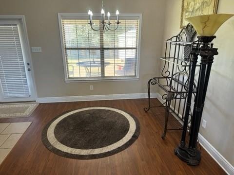 dining space with an inviting chandelier and hardwood / wood-style floors