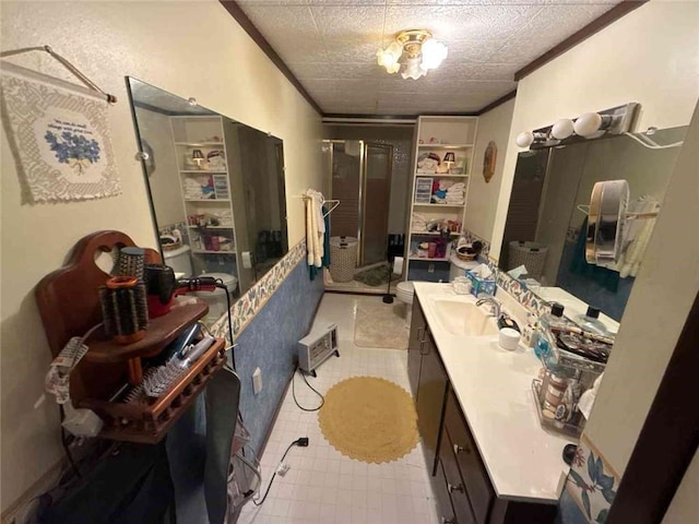 bathroom featuring ornamental molding, a stall shower, and vanity