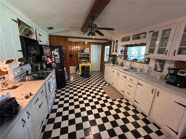 kitchen featuring black appliances, white cabinetry, wood walls, and tile patterned floors