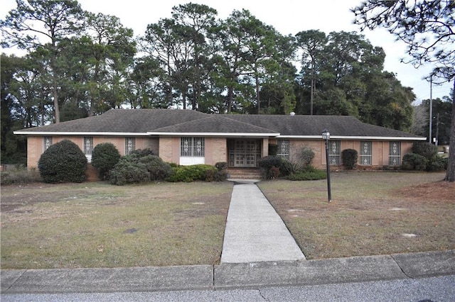 ranch-style home with a front lawn