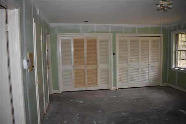 unfurnished bedroom featuring multiple closets