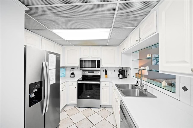 1051 Beach Blvd, Gulf Shores, AL 36542 - kitchen featuring stainless steel appliances, white cabinets, light tile patterned floors, and light countertops