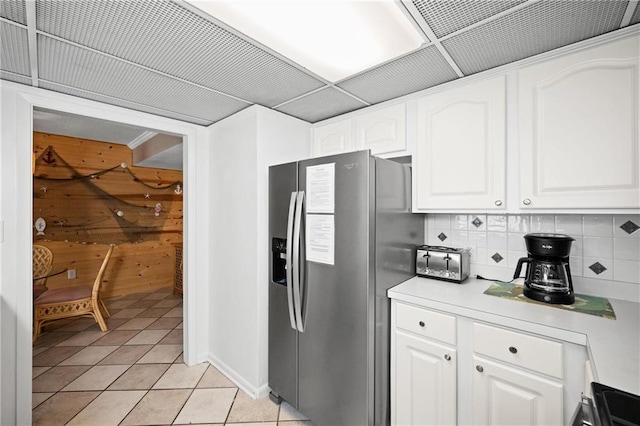 1051 Beach Blvd, Gulf Shores, AL 36542 - kitchen with stainless steel refrigerator with ice dispenser, tasteful backsplash, light tile patterned floors, white cabinetry, and light countertops