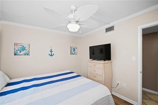 1051 Beach Blvd, Gulf Shores, AL 36542 - bedroom featuring crown molding, ceiling fan, and wood finished floors