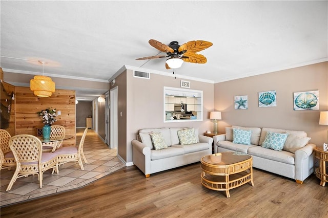 1051 Beach Blvd, Gulf Shores, AL 36542 - living room with ornamental molding, a ceiling fan, and wood finished floors