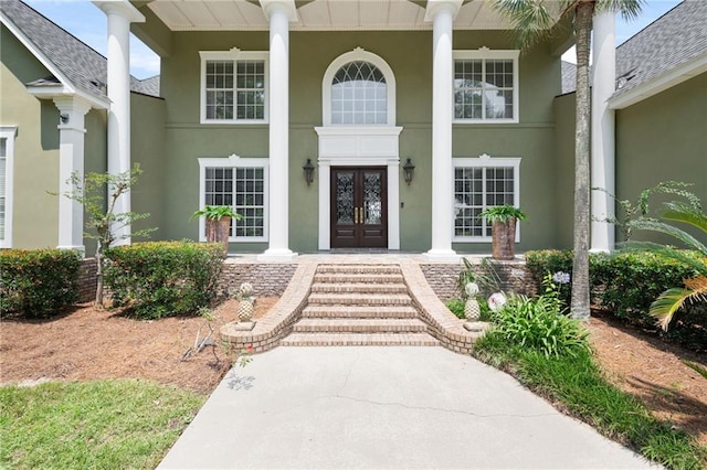 2924 Riverview Pointe Dr S, Theodore, AL 36582 - view of exterior entry featuring french doors, stucco siding, and a porch