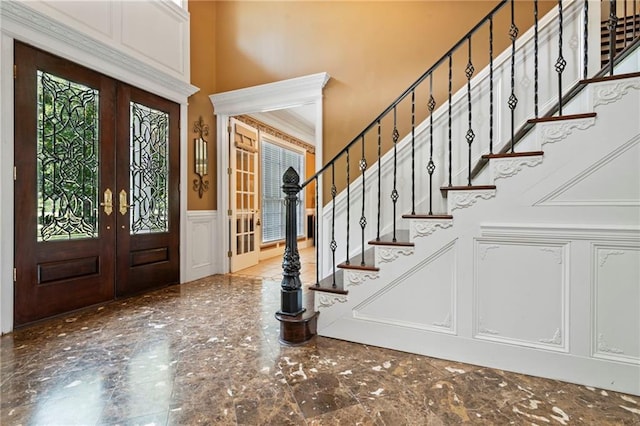 2924 Riverview Pointe Dr S, Theodore, AL 36582 - foyer featuring a decorative wall, french doors, a towering ceiling, wainscoting, and stairway