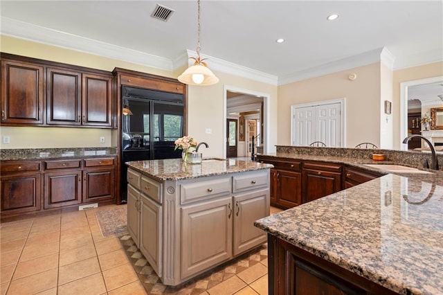 2924 Riverview Pointe Dr S, Theodore, AL 36582 - kitchen featuring a sink, a kitchen island with sink, pendant lighting, crown molding, and stone counters