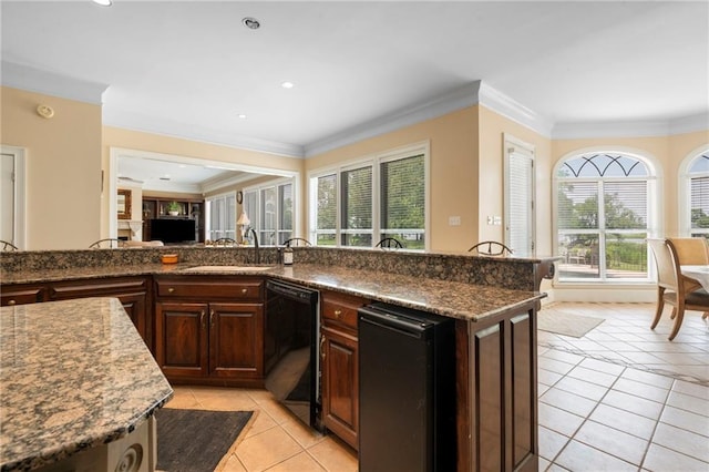 2924 Riverview Pointe Dr S, Theodore, AL 36582 - kitchen with black dishwasher, light tile patterned floors, a sink, dark brown cabinets, and open floor plan