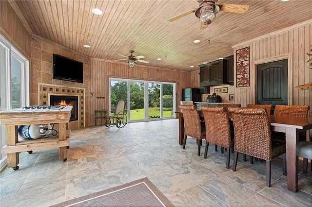 2924 Riverview Pointe Dr S, Theodore, AL 36582 - dining area featuring ceiling fan, wood ceiling, stone tile floors, recessed lighting, and wooden walls