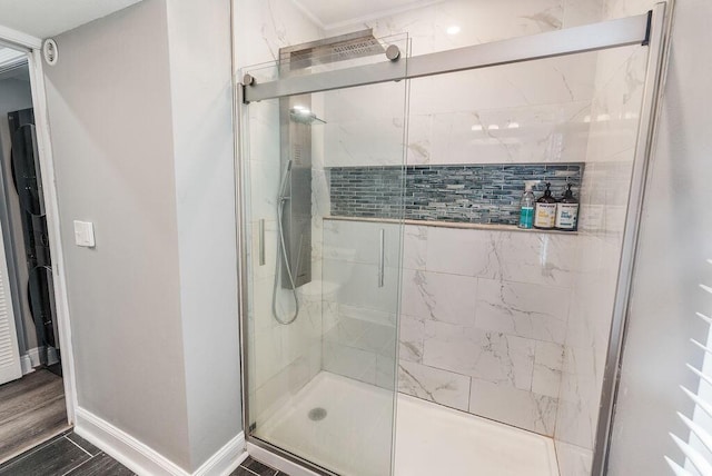 bathroom featuring hardwood / wood-style flooring and a shower with shower door