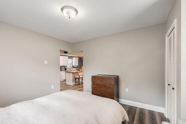 bedroom featuring a closet and dark hardwood / wood-style floors