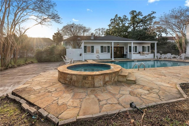 view of pool with an in ground hot tub and a patio area