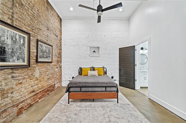 204 Conti St Unit 1A, Mobile, AL 36602 - bedroom with finished concrete floors, ensuite bath, a ceiling fan, and baseboards