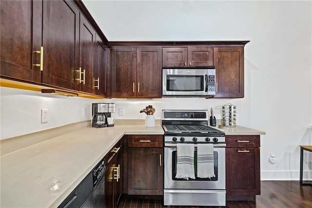 204 Conti St Unit 1A, Mobile, AL 36602 - kitchen featuring stainless steel appliances, light countertops, dark wood-type flooring, and dark brown cabinetry