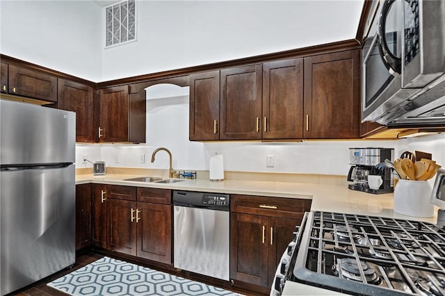204 Conti St Unit 1A, Mobile, AL 36602 - kitchen with stainless steel appliances, a sink, dark brown cabinets, and light countertops