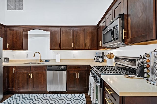 204 Conti St Unit 1A, Mobile, AL 36602 - kitchen featuring stainless steel appliances, a sink, and dark brown cabinetry