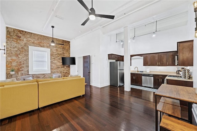 204 Conti St Unit 1A, Mobile, AL 36602 - living room with a ceiling fan, dark wood finished floors, a towering ceiling, baseboards, and brick wall