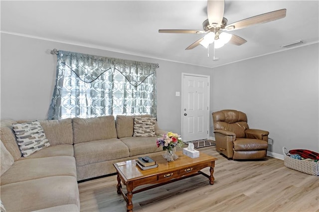 living room with ceiling fan, wood-type flooring, and ornamental molding